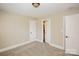 Neutral bedroom with carpet and baseboard trim features an open door to a bathroom at 1125 Bugle Ln, Newton, NC 28658