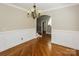 Elegant dining room with hardwood floors, wainscoting detail, and decorative chandelier at 1125 Bugle Ln, Newton, NC 28658