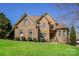 Beautiful brick and stone home featuring manicured lawn, mature landscaping and inviting architectural details at 1125 Bugle Ln, Newton, NC 28658