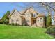 Handsome brick and stone home with lush green lawn, showcasing classic design and curb appeal at 1125 Bugle Ln, Newton, NC 28658