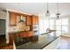 Well-appointed kitchen island with dark granite counters, stainless steel appliances, and tile backsplash at 1125 Bugle Ln, Newton, NC 28658