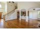 Spacious living room with hardwood floors, staircase, and open layout into the kitchen area at 1125 Bugle Ln, Newton, NC 28658