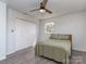 Well-lit bedroom featuring hardwood floors and a full closet with two windows for natural lighting at 114 Joe Teague Rd, Hickory, NC 28601