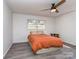 Bright bedroom with hardwood floors, a ceiling fan, and natural light from the window at 114 Joe Teague Rd, Hickory, NC 28601