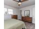 Sunny bedroom with hardwood floors and a dresser with two windows streaming sunlight at 114 Joe Teague Rd, Hickory, NC 28601