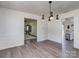 Dining room showcasing modern lighting, wood floors, and seamless flow to other rooms at 114 Joe Teague Rd, Hickory, NC 28601