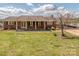 Charming brick home featuring a covered porch and well-maintained front yard at 114 Joe Teague Rd, Hickory, NC 28601