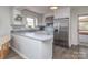 Efficient white kitchen featuring stainless steel refrigerator, ample counter space, and a breakfast bar at 114 Joe Teague Rd, Hickory, NC 28601