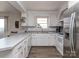 Efficient white kitchen with stainless steel refrigerator, ample counter space, and updated appliances at 114 Joe Teague Rd, Hickory, NC 28601