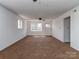 Open living room with multiple windows, neutral walls, and carpet at 114 Joe Teague Rd, Hickory, NC 28601