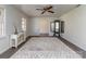 Bright living room featuring a large rug, ceiling fan, and view to another room at 114 Joe Teague Rd, Hickory, NC 28601