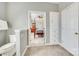 Bright bathroom boasts tile floors, built-in storage, and an open view to the bedroom with a four-poster bed at 122 Blandina Ct, Fort Mill, SC 29708