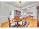 Spacious dining room showcasing hardwood floors, elegant trim, and convenient access to other living areas at 122 Blandina Ct, Fort Mill, SC 29708