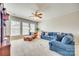 Comfortable living room featuring large windows, plush carpeting, and stylish blue sofas creating an ideal place for relaxation at 122 Blandina Ct, Fort Mill, SC 29708