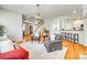 Bright living room featuring a staircase, hardwood floors, and kitchen view at 122 Blandina Ct, Fort Mill, SC 29708