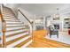 Inviting living space seamlessly flows into kitchen, showcasing hardwood floors and a charming fireplace for relaxed living and entertaining at 122 Blandina Ct, Fort Mill, SC 29708
