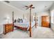 Serene main bedroom featuring carpeted floors, a decorative ceiling fan, and an en-suite bathroom for comfortable living at 122 Blandina Ct, Fort Mill, SC 29708