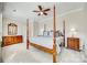 Spacious main bedroom featuring carpeted floors, four-poster bed, and ample natural light creating a relaxing retreat at 122 Blandina Ct, Fort Mill, SC 29708