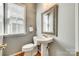 Cozy powder room features a pedestal sink, decorative mirror and wooden floors, providing a functional space for guests at 122 Blandina Ct, Fort Mill, SC 29708