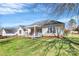 Exterior view of the house from the expansive backyard under a bright blue sky at 1229 Kent Dr, Lancaster, SC 29720