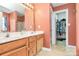 Bathroom vanity with double sinks, wood cabinets, and walk in closet at 1229 Kent Dr, Lancaster, SC 29720