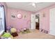Pink bedroom featuring toys, stuffed animals, wall art, and door to hallway at 1229 Kent Dr, Lancaster, SC 29720