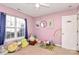 Pink bedroom with stuffed animals, play area, window, and decorated walls at 1229 Kent Dr, Lancaster, SC 29720