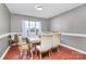 A well-lit dining room with a table and chairs, and a window overlooking the outdoors at 1229 Kent Dr, Lancaster, SC 29720