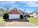Well-maintained home featuring a two-car garage, brick accents, and established landscaping at 1229 Kent Dr, Lancaster, SC 29720