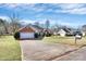 Charming front exterior of the home with a two-car garage, a manicured lawn, and a spacious driveway at 1229 Kent Dr, Lancaster, SC 29720