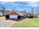 Inviting front exterior with a brick accent, two car garage, and well-kept landscaping at 1229 Kent Dr, Lancaster, SC 29720