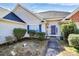 Home exterior featuring a blue door and shutters and manicured landscaping at 1229 Kent Dr, Lancaster, SC 29720