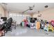 Cluttered garage with a desk, chair, overhead door, storage bins, and assorted items at 1229 Kent Dr, Lancaster, SC 29720