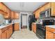 Traditional kitchen with wood cabinets, black appliances and light countertops at 1229 Kent Dr, Lancaster, SC 29720