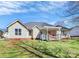 Backyard view of home featuring a covered deck and well-maintained lawn at 1229 Kent Dr, Lancaster, SC 29720