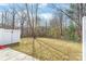 Backyard featuring a white privacy fence, a concrete patio, and sparse grass at 130 Clydesdale Ct, Matthews, NC 28104