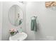 Chic half bathroom featuring modern fixtures, stylish mirror, and a vanity with a vessel sink at 130 Clydesdale Ct, Matthews, NC 28104