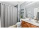 Bathroom featuring a shower with a gray shower curtain and wood vanity at 130 Clydesdale Ct, Matthews, NC 28104