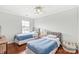 Bedroom featuring twin beds, hardwood floors, a ceiling fan, and neutral color scheme at 130 Clydesdale Ct, Matthews, NC 28104