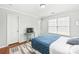 Bright bedroom featuring a blue quilted bedspread, wood flooring, and a window with natural light at 130 Clydesdale Ct, Matthews, NC 28104