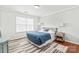 Inviting bedroom with hardwood floors, a large window, and a comfortable bed with stylish linens at 130 Clydesdale Ct, Matthews, NC 28104