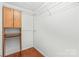 Walk-in closet with a wood floor, wire shelving, hanging racks and a wood cabinet at 130 Clydesdale Ct, Matthews, NC 28104
