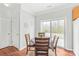 Bright dining area featuring hardwood floors, a table with seating for four, and sliding glass doors to the patio at 130 Clydesdale Ct, Matthews, NC 28104