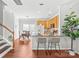 Kitchen with granite countertops, stainless steel appliances, breakfast bar, and hardwood floors at 130 Clydesdale Ct, Matthews, NC 28104