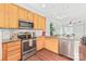 Kitchen with granite countertops, stainless steel appliances, and light wood cabinets, offering an open layout at 130 Clydesdale Ct, Matthews, NC 28104