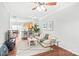 Bright living room with hardwood floors, crown molding, and an open floor plan leading to the kitchen and dining area at 130 Clydesdale Ct, Matthews, NC 28104