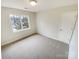 Bedroom features neutral carpet, and a window with a view of the outdoors and a white door at 1400 Wessex Ct, Monroe, NC 28110