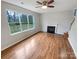 Bright living room featuring a cozy fireplace and large windows at 1400 Wessex Ct, Monroe, NC 28110