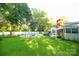 Large backyard featuring an in-ground pool, patio, and mature trees at 142 Wilson Ne St, Concord, NC 28025