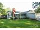 Backyard featuring well-maintained lawn, deck, and sunroom addition at 142 Wilson Ne St, Concord, NC 28025